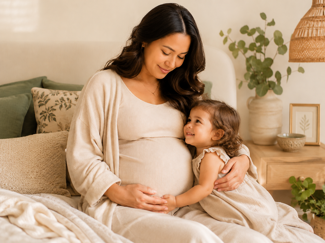 Pregnant mother sitting in a calm bedroom while cuddling her older toddler, representing breastfeeding during pregnancy, tandem nursing decisions, and gentle weaning choices.