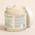 CABAID Wean & Ease Cooling & Soothing Breast Cream in an open glass jar with ribbed cap, showing side label directions, warnings, and sensitive skin information.